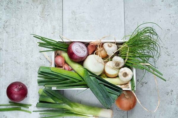 Box of onions, scallions, shallots, and garlic