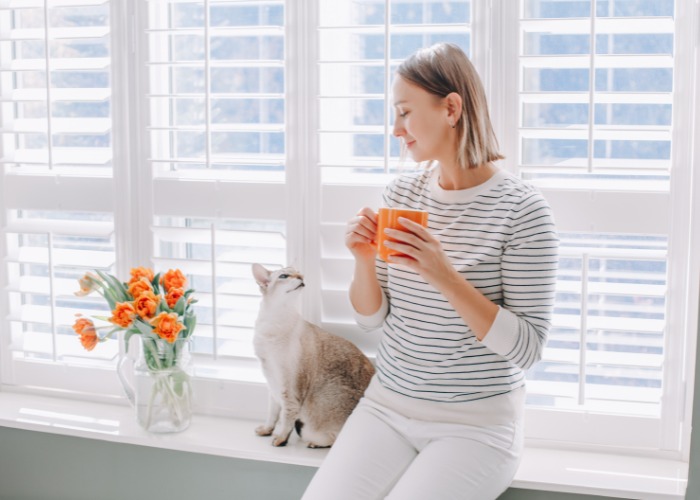 Woman sitting and having a conversation with her cat