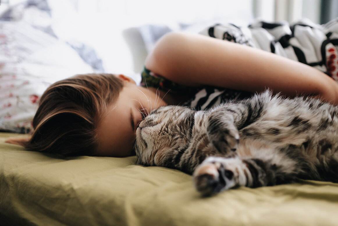 Woman bonding with a cat.