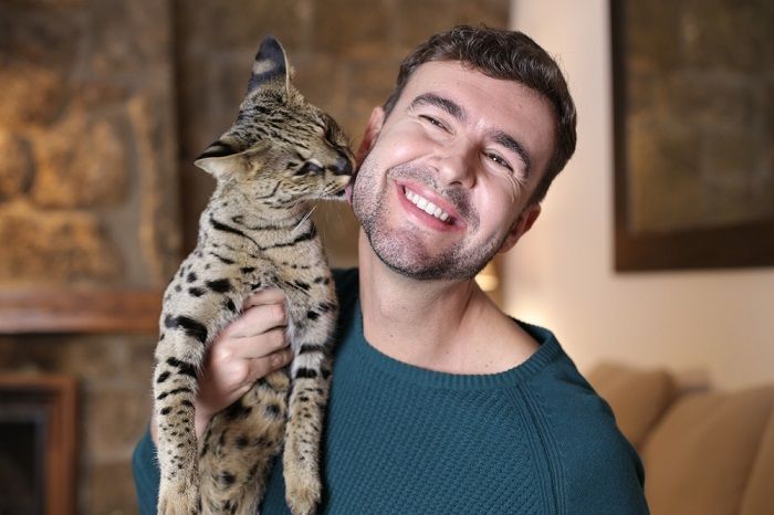 cat licking man