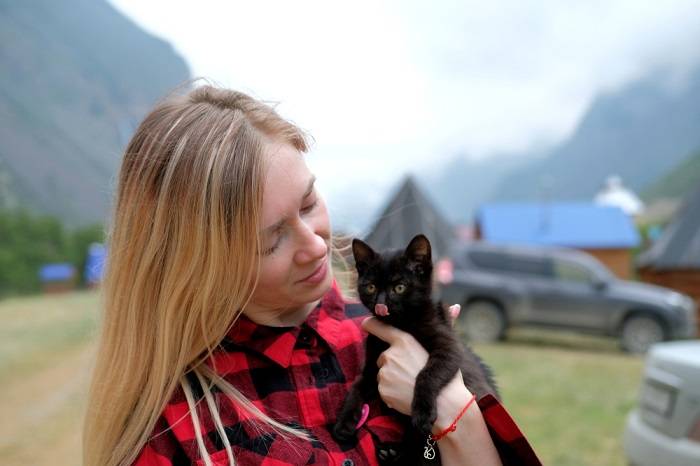 girl with black kitten