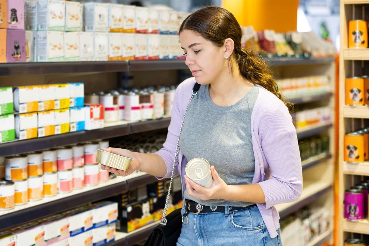 Woman shopping in the pet food aisle